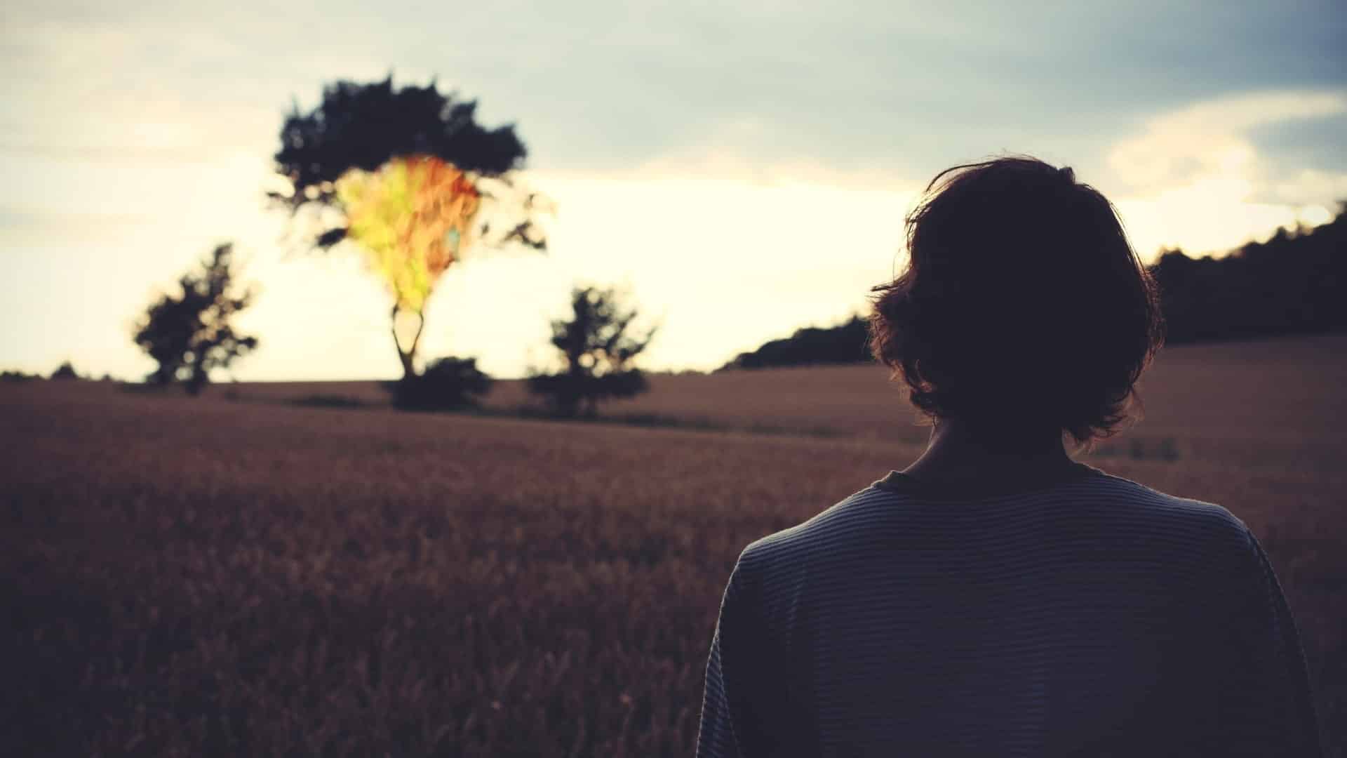Woman looking at a tree that is on fire