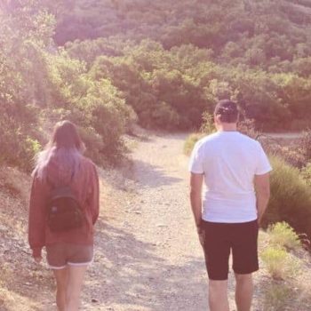 Man and a woman walking on a hiking trail